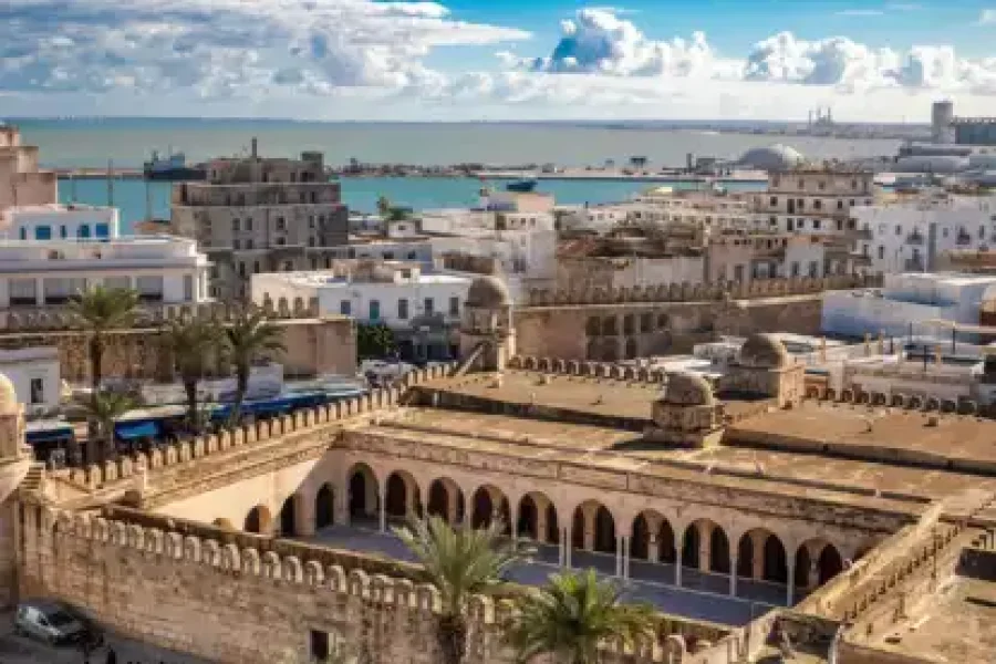 Colorful street in Sousse Medina with traditional architecture and market atmosphere